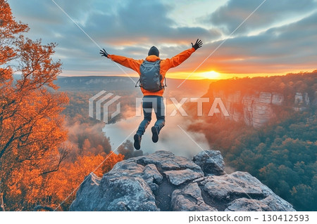 Silhouette of a person jumping on the mountain top 130412593