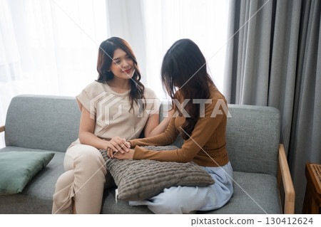 Supportive Friends Sharing a Special Moment Together in a Cozy and Inviting Setting Supportive Friends Sharing a Special Moment Together in a Cozy and Inviting Setting 130412624