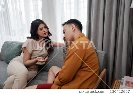 A Heartfelt Conversation Between a Couple in a Cozy, Affectionate Living Room 130412697