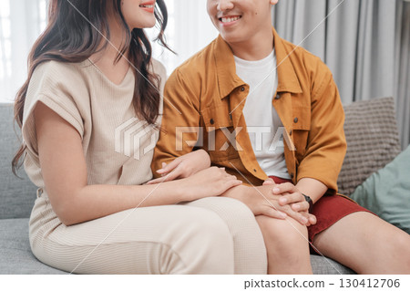 A Young Couple Spending Quality Time Enjoying Intimate Moments on a Cozy Sofa A Young Couple Spending Quality Time Enjoying Intimate Moments on a Cozy Sofa 130412706