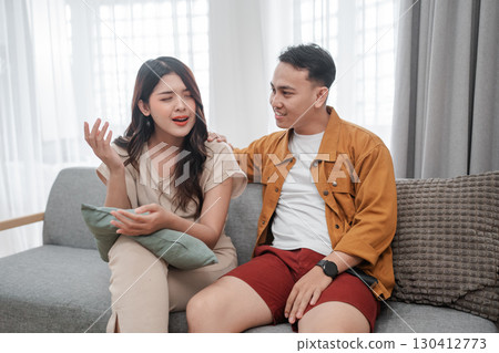 A Casual and Relaxed Conversation Taking Place Between Friends on a Cozy Sofa 130412773