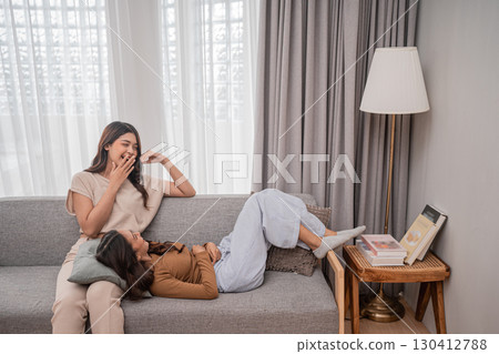 Joyful Moments A Mother and Her Child Enjoying Relaxation at Home Together Joyful Moments A Mother and Her Child Enjoying Relaxation at Home Together 130412788