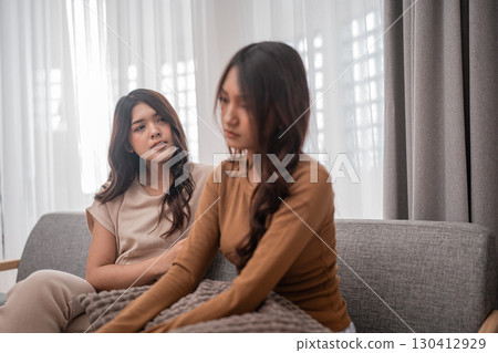An Intimate Conversation Shared Between Two Women in a Cozy Living Room Setting An Intimate Conversation Shared Between Two Women in a Cozy Living Room Setting 130412929