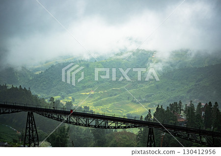 Bridge view over misty terraced mountains in Sapa, Vietnam 130412956