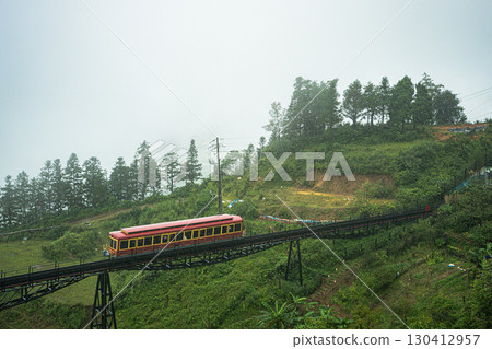 Red train crossing a mountain bridge in Sapa, Vietnam 130412957