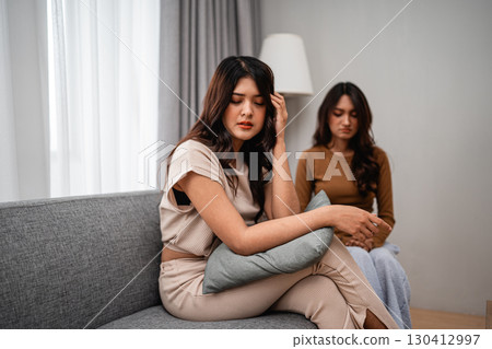 Emotional support exchanged between friends in a calm indoor environment setting 130412997