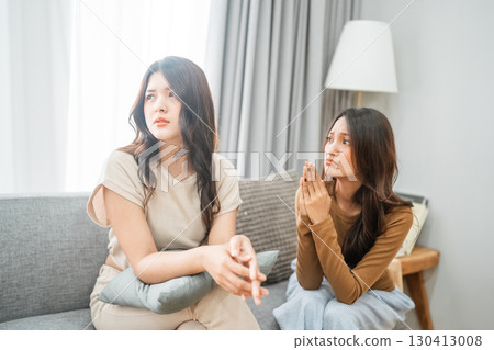 Two Women Engaged in a Deep Conversation While Relaxing in a Cozy Living Room Two Women Engaged in a Deep Conversation While Relaxing in a Cozy Living Room 130413008