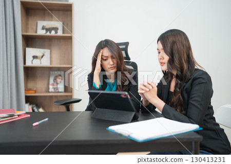 Two Businesswomen Engaged in a Serious Discussion in a Modern Office Setting 130413231