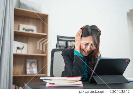 A Stressed Businesswoman in Her Home Office Struggling with Technology and Setup 130413242