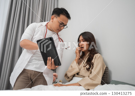 A Doctor Consultation Involves Engaging with a Patient in a Modern Healthcare Setting A Doctor Consultation Involves Engaging with a Patient in a Modern Healthcare Setting 130413275