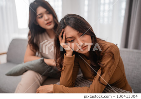 Women Sharing Vulnerability and Emotional Support in a Cozy Living Room Women Sharing Vulnerability and Emotional Support in a Cozy Living Room 130413304