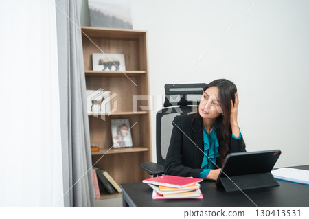 A Business Woman Deeply Reflecting on Strategic Solutions in a Modern Office Setting 130413531