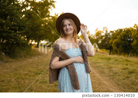 Pregnant woman in summer dress enjoying nature outdoors 130414010