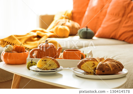 Autumnal living room decor with pumpkins, tea set and cake. Autumnal living room decor with pumpkins, tea set and cake. 130414578