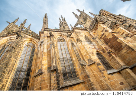 Prague, Czech Republic, August 6, 2023. Side view of St. Vitus Cathedral on a rainy day, detail of the gargoyles and spires. Travel destinations. Prague, Czech Republic, August 6, 2023. Side view of St. Vitus Cathedral on a rainy day, detail of the gargoyles and spires. Travel destinations. 130414793