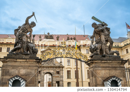 Prague, Czech Republic, August 6, 2023. Hradcany Square with Matthias Gate, the main entrance to the Castle's first courtyard. Statues of fighting titans on either side. Travel destinations. 130414794