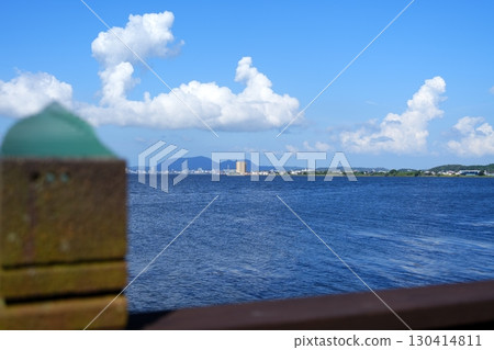 View of Matsue city across Lake Shinji from a cafe in Shimane Prefecture and white clouds floating in the blue sky 130414811