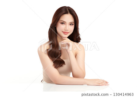 A beautiful young Asian woman with clean, fresh skin against a white background. Skincare, facial treatment, cosmetology, beauty, and spa. An elegant portrait of an Asian woman. 130414963