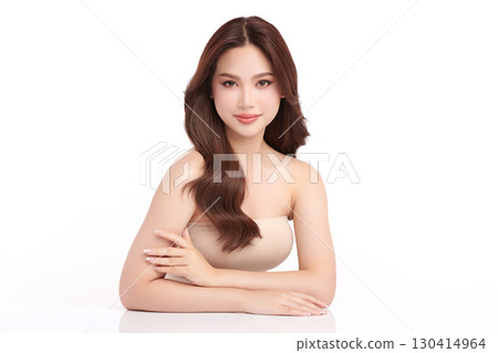 A beautiful young Asian woman with clean, fresh skin against a white background. Skincare, facial treatment, cosmetology, beauty, and spa. An elegant portrait of an Asian woman. 130414964