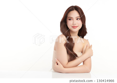 A beautiful young Asian woman with clean, fresh skin against a white background. Skincare, facial treatment, cosmetology, beauty, and spa. An elegant portrait of an Asian woman. 130414966