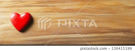 Red heart shape resting on a natural wood surface, offering ample copy space, perfect for celebrating valentines day, mothers day, or spring themed projects and messages 130415199