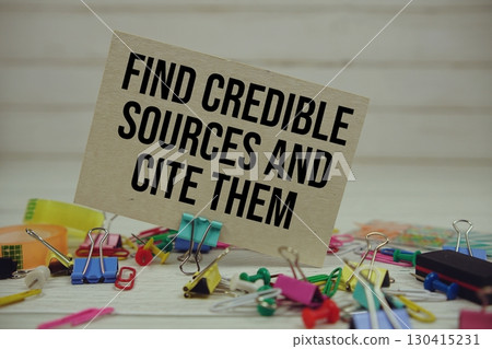 Find Credible Sources And Cite Them text on paper card with stationary on wooden background Find Credible Sources And Cite Them text on paper card with stationary on wooden background 130415231