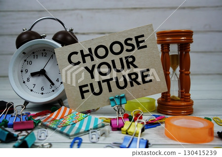 Choose Your Future text on paper card with alarm clock and stationary on wooden background Choose Your Future text on paper card with alarm clock and stationary on wooden background 130415239