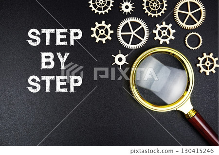 Step By Step text message with magnifying glass on black background Step By Step text message with magnifying glass on black background 130415246