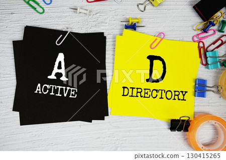 AD - Active Directory text on stick note with stationery on concrete background 130415265