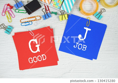GB - Good Job text on stick note with stationery on concrete background GB - Good Job text on stick note with stationery on concrete background 130415280