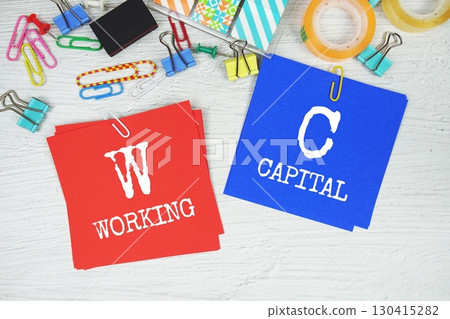 WC - Working Capital text on stick note with stationery on concrete background 130415282