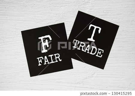FT - Fair Trade text on stick note on concrete background FT - Fair Trade text on stick note on concrete background 130415295
