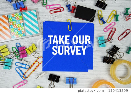 Take Our Survey text on stick note with stationery on concrete background Take Our Survey text on stick note with stationery on concrete background 130415299