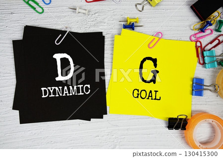 DG - Dynamic Goal text on stick note with stationery on concrete background 130415300