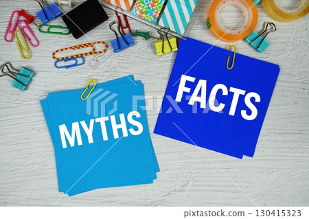 Myths vs Facts text on stick note with stationery on concrete background 130415323