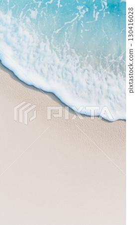 Crystal clear turquoise ocean water gently washing onto the pristine white sand beach creating a serene and relaxing summer holiday atmosphere 130416028