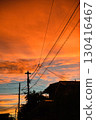 A vibrant orange sunset and the silhouette of a residential area 130416467