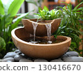 Minimalist garden water fountain with water flowing to the water pond	 130416670