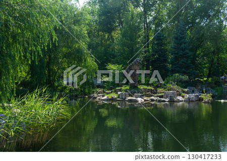 Summer landscape with pond and trees in the park in the morning. Summer landscape with pond and trees in the park in the morning. 130417233