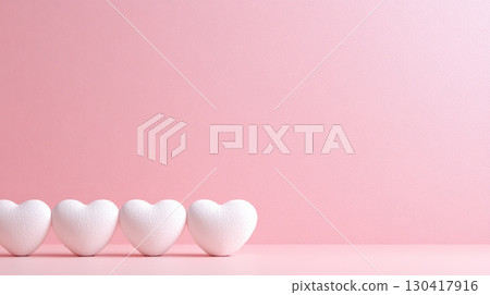 Four white hearts are standing on a pink surface with a pink background, creating a romantic atmosphere perfect for valentine's day, mother's day, or spring celebrations 130417916