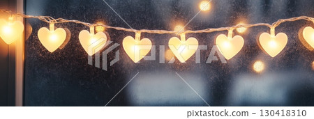 Heart shaped fairy lights glowing on a window, creating a warm, romantic ambiance ideal for valentine's day, anniversaries, and celebrating love Heart shaped fairy lights glowing on a window, creating a warm, romantic ambiance ideal for valentine's day, anniversaries, and celebrating love 130418310