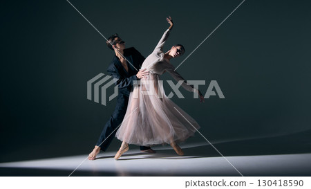 Ballet duet performance with elegant lift, refined balance captured under dramatic light 130418590