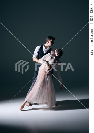 Ballet couple in dramatic embrace with elegant posture and emotional tension 130418609