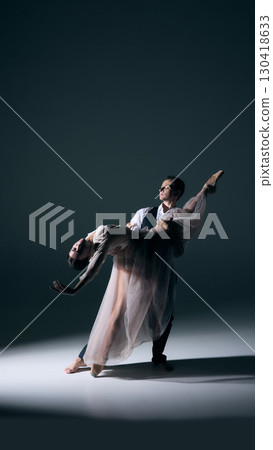 Ballet partners in dramatic lift under spotlight with emotion Ballet partners in dramatic lift under spotlight with emotion 130418633