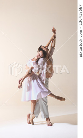 Ballet duet pose with woman in flowing dress leaning on partner in harmony Ballet duet pose with woman in flowing dress leaning on partner in harmony 130418667