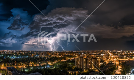 Dramatic lightning storm illuminating a vibrant cityscape at night, showcasing the powerful interplay of nature and urban life, creating an awe inspiring atmosphere filled with energy 130418835