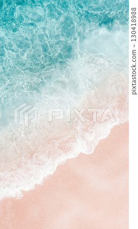 Crystal clear turquoise ocean waves gently rolling onto a pristine pink sandy beach, creating a serene and idyllic tropical paradise, perfect for summer holidays and travel destinations 130418988
