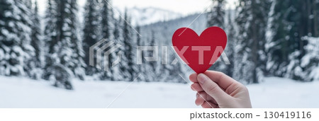 Hand holding a vibrant red heart in a serene snowy forest, embracing love and celebrating valentines day amidst the enchanting beauty of a winter wonderland Hand holding a vibrant red heart in a serene snowy forest, embracing love and celebrating valentines day amidst the enchanting beauty of a winter wonderland 130419116