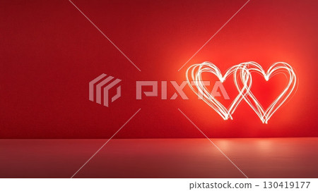 Light painting of two hearts glowing on a red background creates a romantic atmosphere ideal for valentine's day, women's day, or any spring celebration of love and affection 130419177