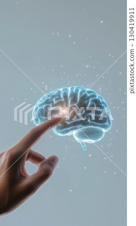 Doctor's finger interacts with a holographic projection of a human brain, symbolizing advancements in medical technology and neurological research 130419911